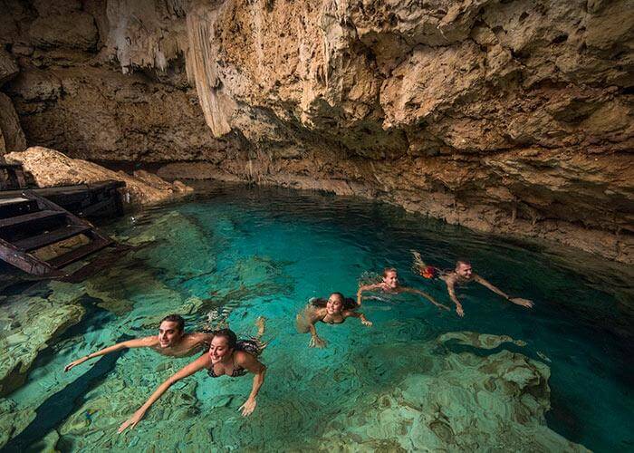 people swimming in cenotes 
