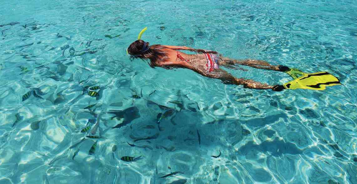 girl snorkeling in isla mujeres sea